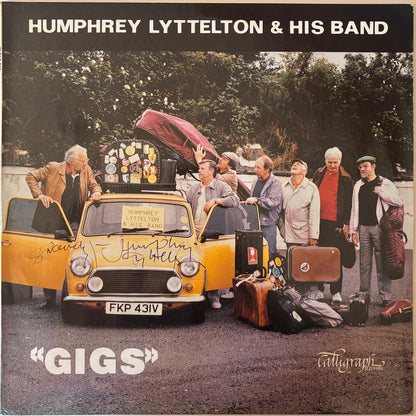 Album cover for 'Gigs' by Humphrey Lyttelton & His Band featuring a yellow car and people with suitcases.