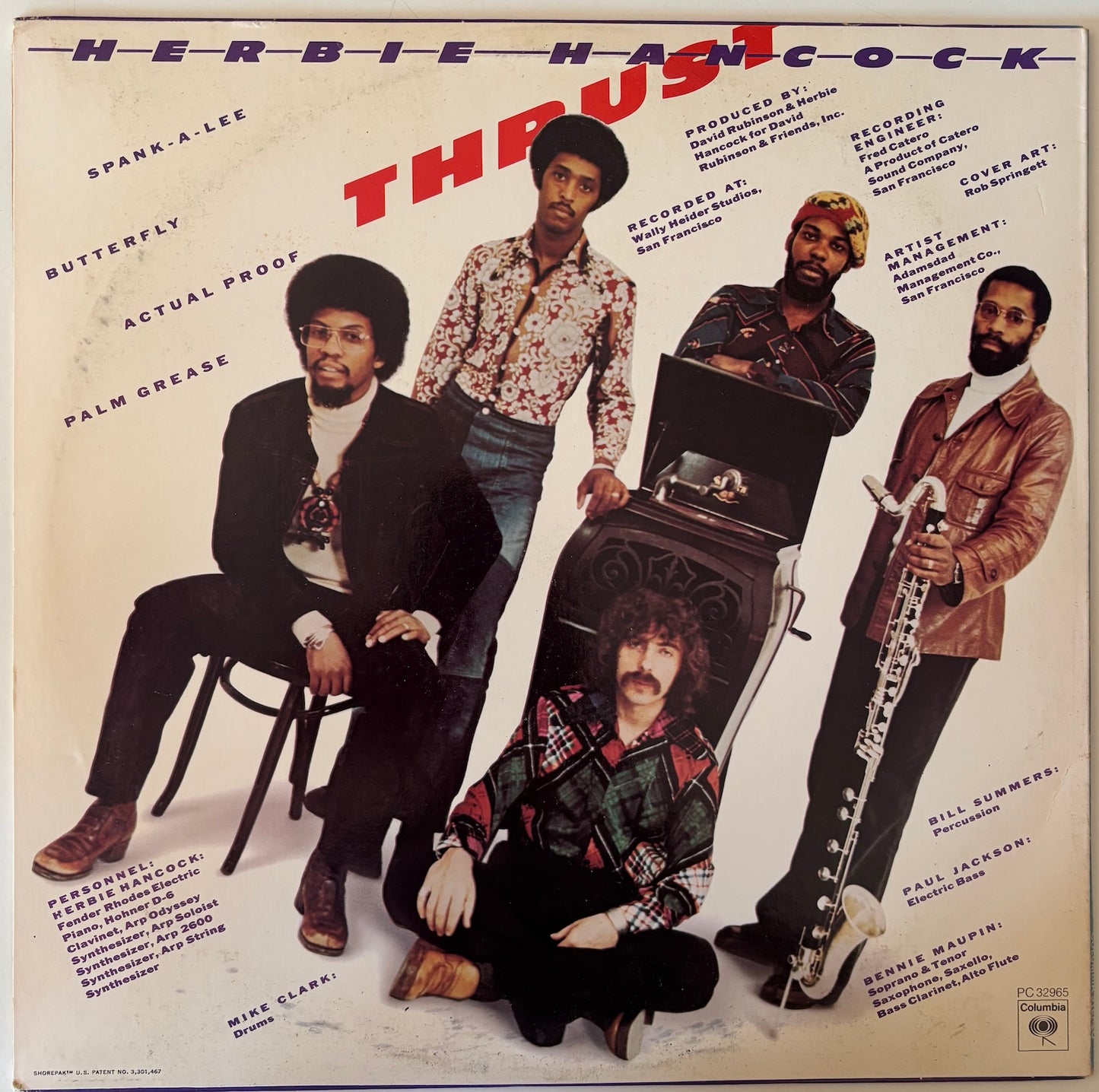 Album cover featuring Herbie Hancock and his band with text and images of musical instruments.