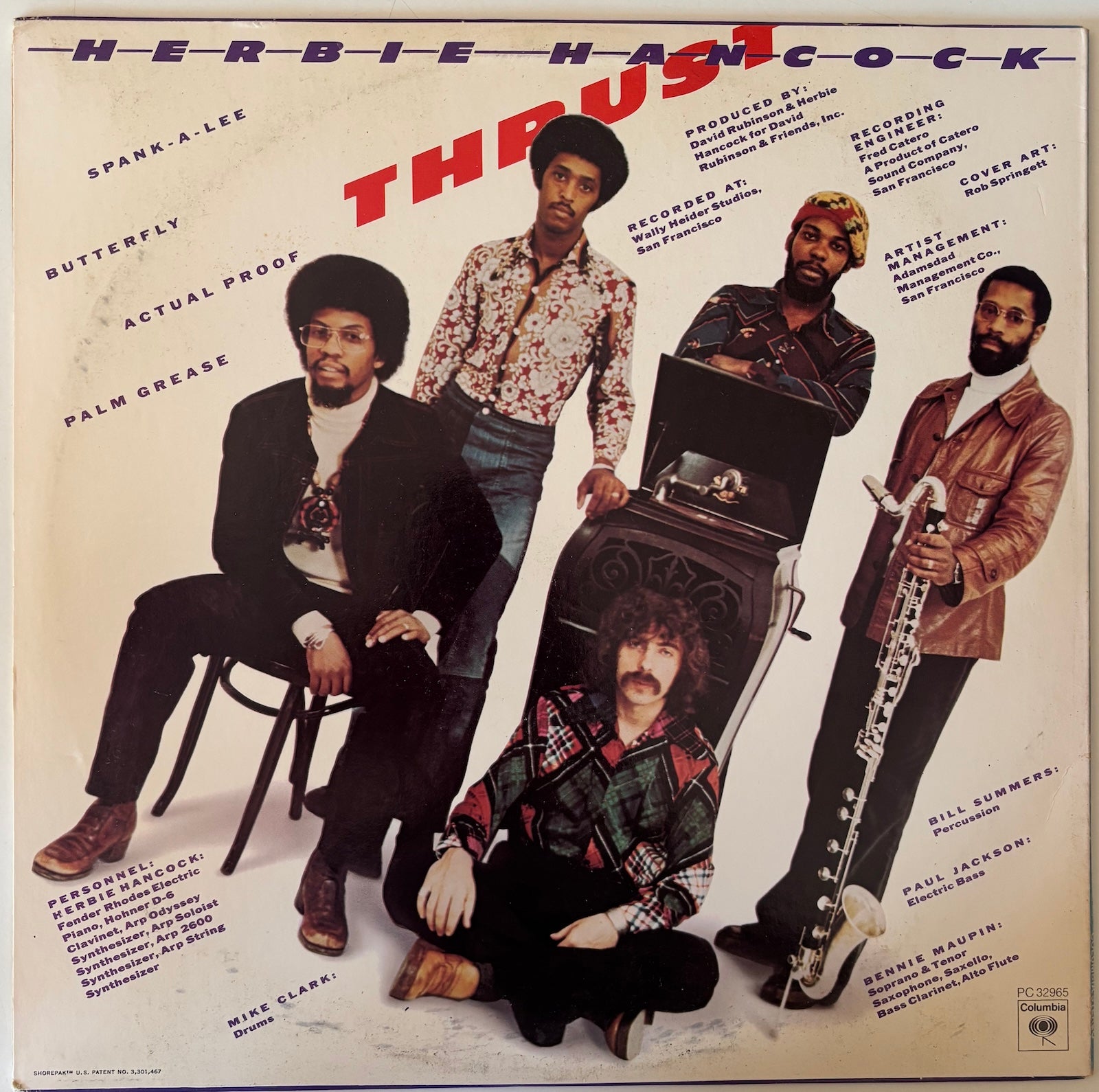 Album cover featuring Herbie Hancock and his band with text and images of musical instruments.