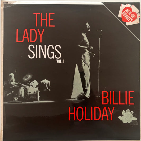 Album cover of 'The Lady Sings Vol. 1' by Billie Holiday with a black and white image of a man singing into a microphone.