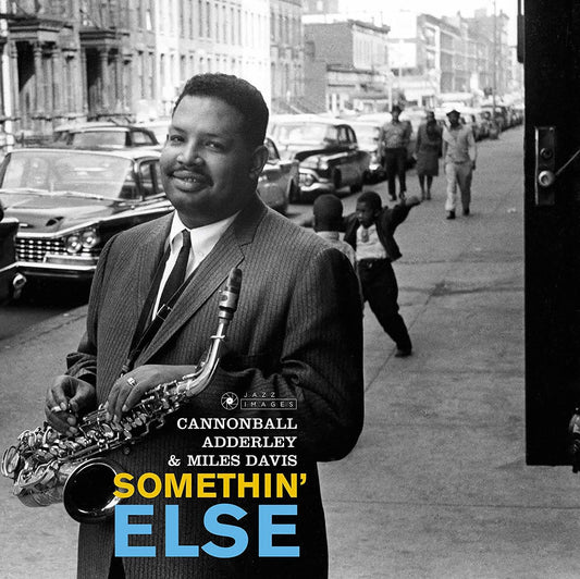 Album cover with a man playing saxophone on a city street, featuring text for Cannonball Adderley and Miles Davis' 'Somethin' Else'.
